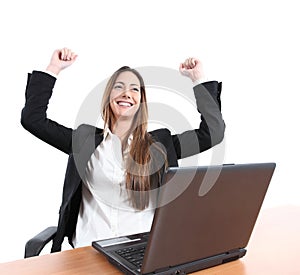 Euphoric businesswoman in an office with a laptop photo