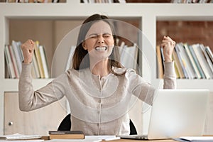 Euphoric female student celebrating received high score evaluation tests results.