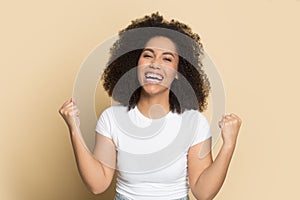 Euphoric laughing happy african american young lady making yes gesture.