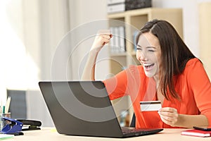 Euphoric shopper buying online photo