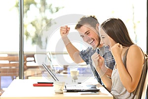 Euphoric students watching exam results photo