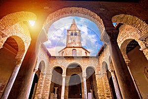 Euphrasian Basilica in Porec arcades and tower sun haze view photo