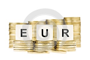 EUR (Euro Currency) on Gold Coin Stack Isolated on White