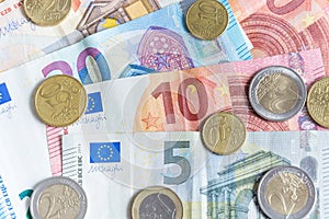 Euro bank notes and coins close up as background