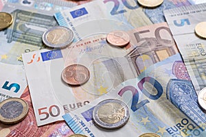 Euro bank notes and coins close up as background