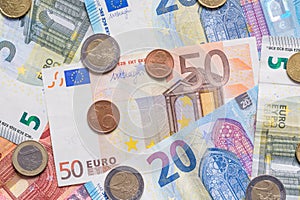 Euro bank notes and coins close up as background