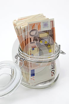 Euro bank notes in a glass jar