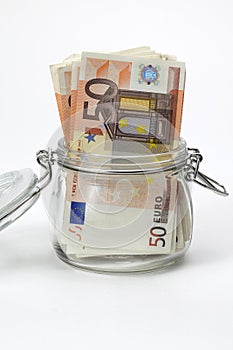 Euro bank notes in a glass jar