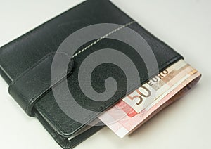 Euro bank notes inside a black wallet