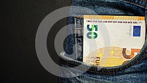 Euro banknote in the front pocket of blue jeans. Money in your pocket, cash.