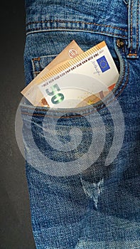 Euro banknote in the front pocket of blue jeans. Money in your pocket, cash.