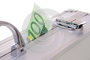 Euro banknote sticking out of suitcase