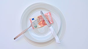 Euro banknote on a white plate, cash in Europe, the cost of lunch in the restaurant