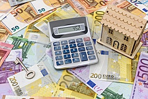 Euro banknotes as background for small toy house