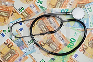 Euro banknotes as background with a stethoscope lying on them