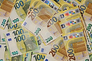 Euro banknotes background.Finance and savings.Two hundred and one hundred euro banknotes.European Union currency
