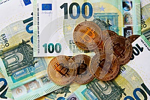 Euro Banknotes and Bitcoin cryptocurrency investing concept. Euro Money and Crypto currency golden bitcoin coin