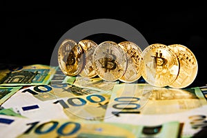 Euro Banknotes and Bitcoin cryptocurrency investing concept. Euro Money and Crypto currency golden bitcoin coin