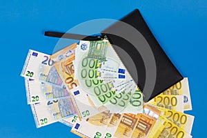 20  50  100  200 Euro banknotes in a black leather wallet close-up. The concept of cash  cash savings  prosperity. Euromoney
