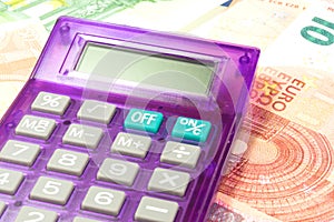 Euro banknotes and a calculator