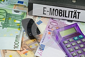 Euro banknotes, calculators, car keys and e-mobility