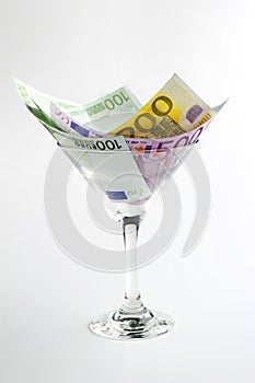 Euro banknotes in cocktail glass