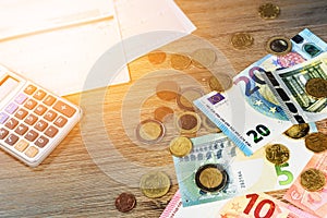 Euro banknotes and coins with bills to pay. Finance concept