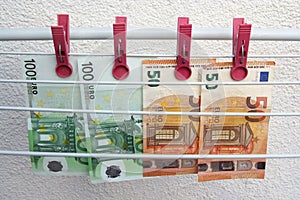Euro banknotes drying. Washed Euro paper bills. Drying euro on a string.