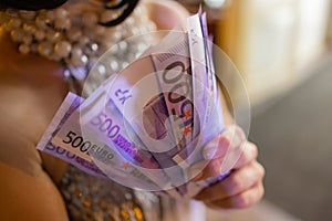 Euro banknotes. Euro Cash background. Close up of woman hands with euro money.
