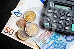 Euro banknotes,euro coins and calculator. photo