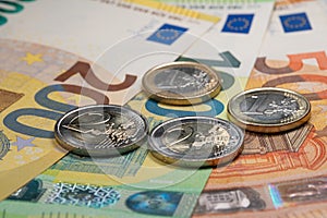 Euro banknotes from fifty to two hundred and Euro coins. European monetary union currency. Economic stimulus package after
