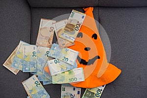 Euro banknotes and Halloween hat