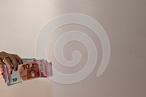 euro banknotes in hand, white background