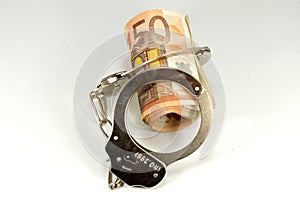 Euro banknotes and handcuffs