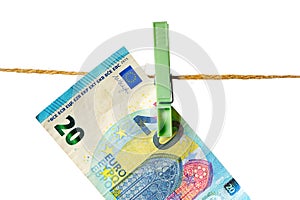 Euro banknotes hanging on a clothesline against white background. Money laundering concept