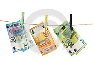 Euro banknotes hanging on a clothesline against white background. Money laundering concept