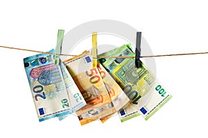 Euro banknotes hanging on a clothesline against white background. Money laundering concept