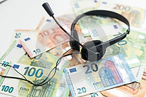euro banknotes headphones headset. Money and technology still life concept.