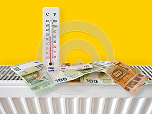 Euro banknotes on home heating radiator with thermometer. Energy crisis and expensive heating costs