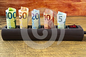 Euro banknotes inserted into an extension socket