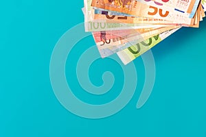 Euro banknotes isolated on blue background