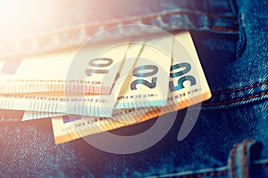 Euro banknotes in jeans pocket. Success, wealth and poverty, poorness concept. Euro currency background with copy space.