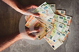 Euro banknotes in man`s hand