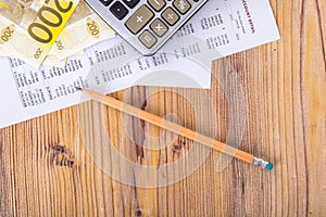 Euro Banknotes with Pencil and Calculator on Earning Report