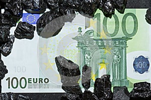 Euro banknotes on raw coal nuggets, bills on coal, power of money and ore