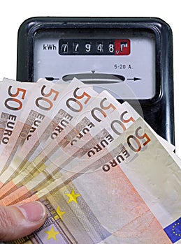 Euro banknotes to pay the electricity bill and the meter