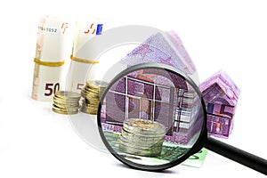 Euro bill House and expenses under magnifying glass