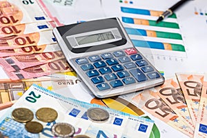 euro bills with calculator and pen on financial settlement