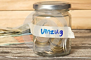 Euro bills and coins, mason jar and savings for moving