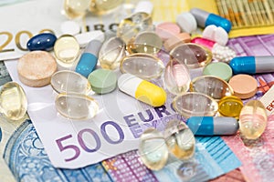 Euro bills and different pill